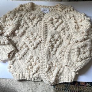 Ivory “bubble” sweater.